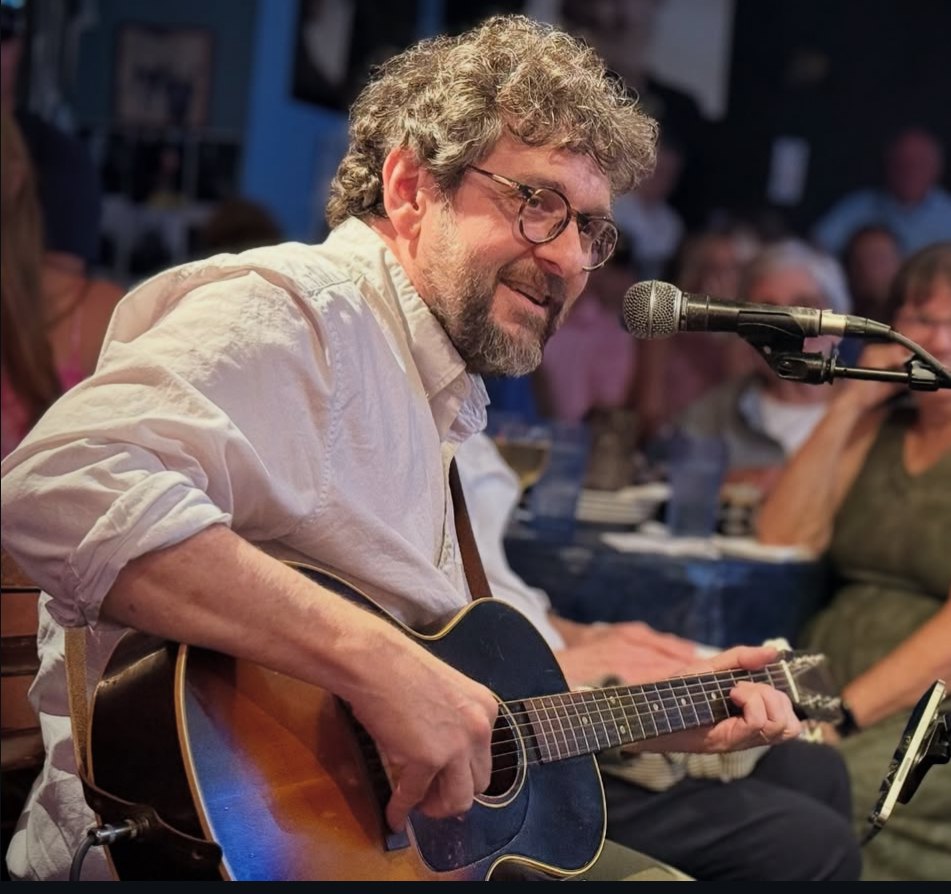 Jay Knowles performing with an acoustic guitar
